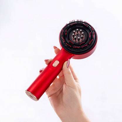 FabRootFlow red electric scalp applicator held with brush head visible