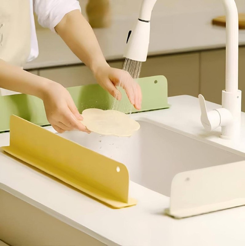 FabSplashLine sink splash guard in use beside a kitchen sink