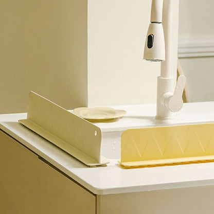 Silicone sink guard positioned beside a white sink
